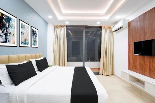 a bedroom with a large bed and a flat screen tv at Townhouse Sector 51 Gurgaon in Gurgaon