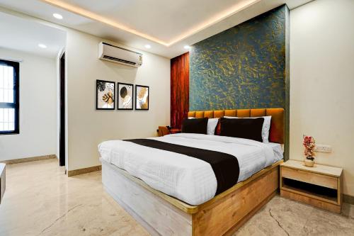 a bedroom with a large bed with a blue wall at Townhouse Sector 51 Gurgaon in Gurgaon