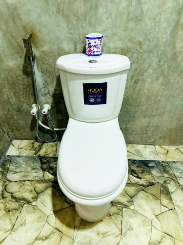 a toilet with a cup on top of it in a bathroom at Sigiri Grand Villa in Sigiriya