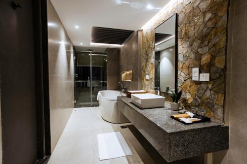 a bathroom with a sink and a toilet and a mirror at Soaltee Westend Lakeside Pokhara in Pokhara