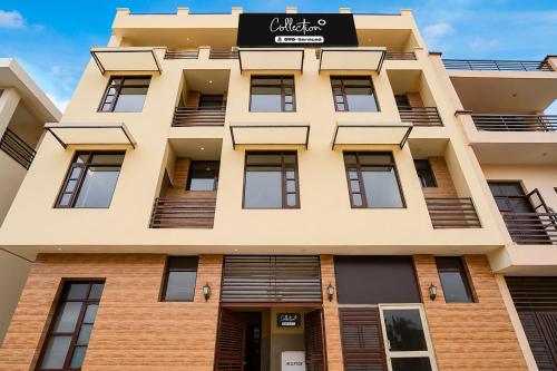 an apartment building with a sign on it at Hotel O Chandigarh Outer Ring Road Formerly Ganesha in Chandīgarh