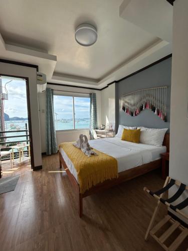 a bedroom with a large bed and a balcony at Morocco Hotel El Nido in El Nido