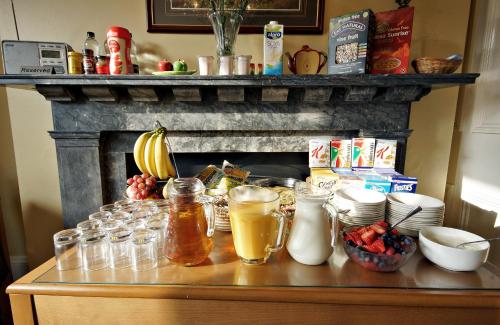 a counter with jars of food and a fireplace at The Apple House in York