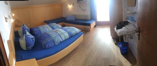 a room with two beds with blue pillows at Ferienwohnungen Marchanger in Niederau