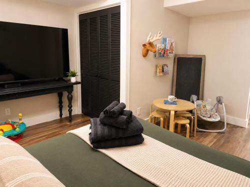 a living room with a couch and a tv and a table at The Hangout House With Bonus Game Room & Foosball in Coeur d'Alene