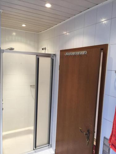 a shower with a glass door in a bathroom at Haus 23 in Korschenbroich