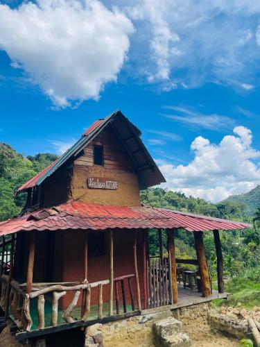 a small building with a red roof at Clay house in Kurukohogama
