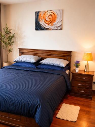 a bedroom with a bed and a painting on the wall at The Signature Suites at Cinnamon life Apartment in Colombo