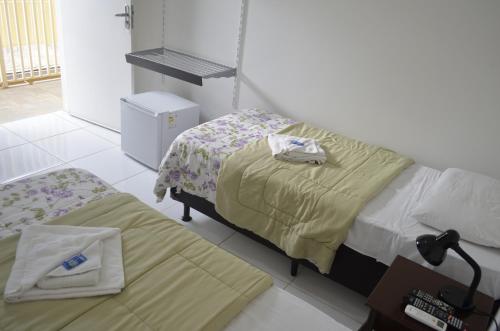 Ένα ή περισσότερα κρεβάτια σε δωμάτιο στο Unibarão Hotel -Próximo as Universidades Unicamp-Puc-Hospitais -Bancos-Restaurantes-Praça Capital -Shopping Dom Pedro - Expo dom pedro-Ceasa