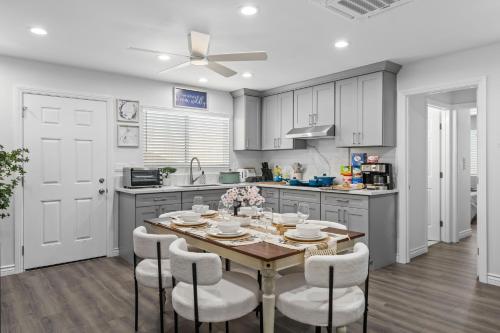 a kitchen with a table and chairs in a kitchen at Entire Private Home with Yard, King Bed, Prime Location, 3 Bedrooms 3 Bathrooms, Available Now in San Diego