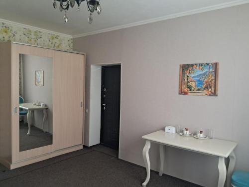 a room with a white table and a sink at Rancho Otel Almaty in Qaskeleng