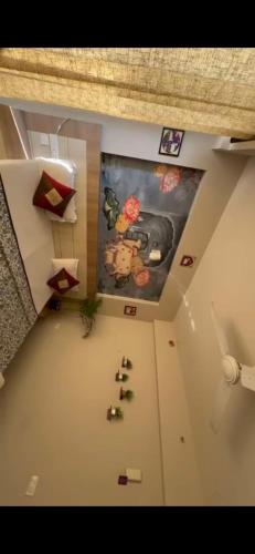 an overhead view of a room with a painting on the wall at Blue Mans Rooms - Near Prem Mandir & ISKCON in Vrindāvan