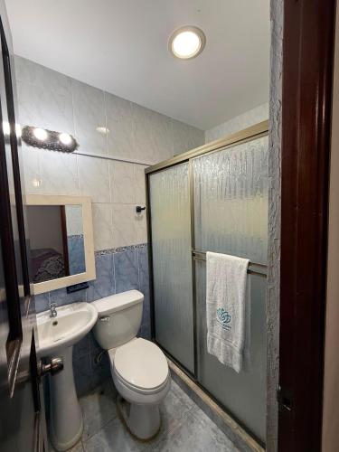 a bathroom with a toilet and a sink at Mansion Sublime in Chitré