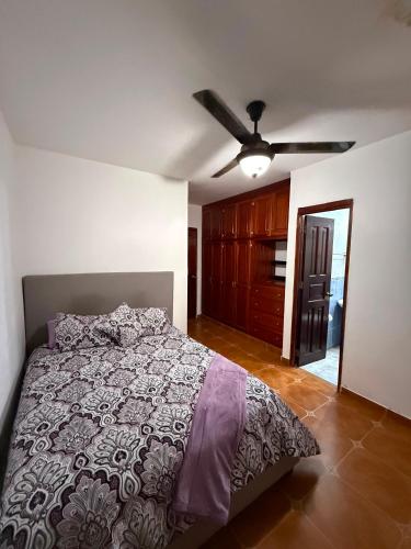 a bedroom with a bed and a ceiling fan at Mansion Sublime in Chitré