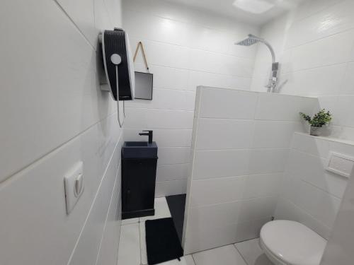 a bathroom with a toilet and a phone on the wall at STUDIO A 2 MN DE L A75 in Usclas-lʼHérault