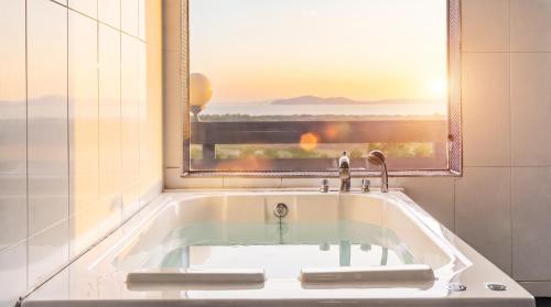 a bath tub in a bathroom with a window at Ganghwa imspa Pension in Incheon