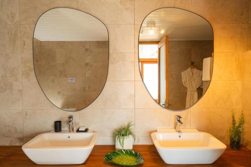 a bathroom with two sinks and two mirrors at Karia Bel - Adult Only +12 in Bozburun