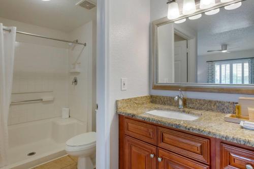 a bathroom with a sink and a toilet and a mirror at Bluegreen Vacations Orlando's Sunshine, Ascend Collection Resort in Orlando