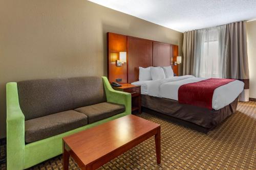 a hotel room with a bed and a couch at Comfort Inn Fort Mill Amusement Park at Carowinds Blvd in Fort Mill