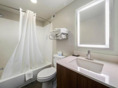 a bathroom with a sink and a toilet and a tub at MainStay Suites Chambersburg in Chambersburg