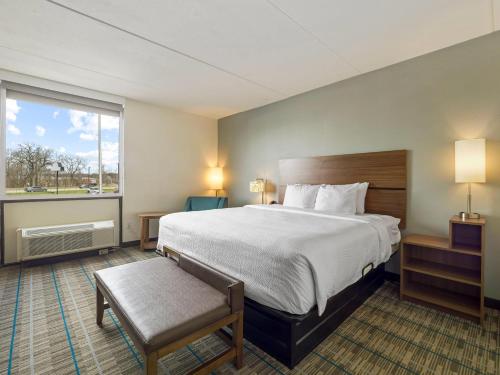 a hotel room with a large bed and a window at MainStay Suites Chambersburg in Chambersburg