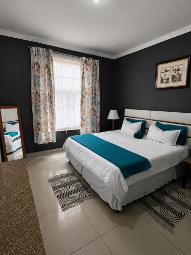 a bedroom with a large bed and a window at 42 On Canterbury in Durban
