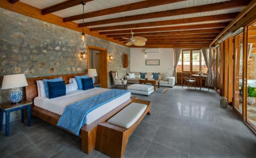 a bedroom with a bed and a living room at Karia Bel - Adult Only +12 in Bozburun
