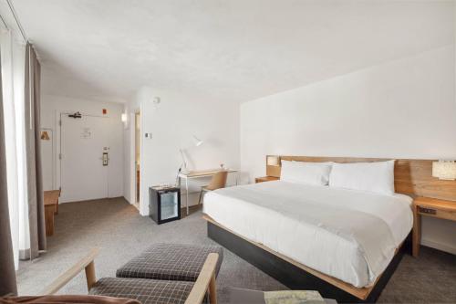 a hotel room with a bed and a desk and a bedroom at Sun Lodge, an Ascend Collection Hotel in Peru