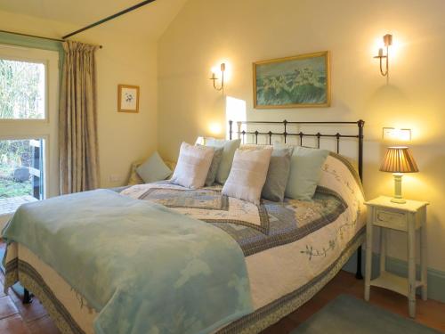 a bedroom with a large bed and a window at Appletree Cottage Fressingfield in Fressingfield