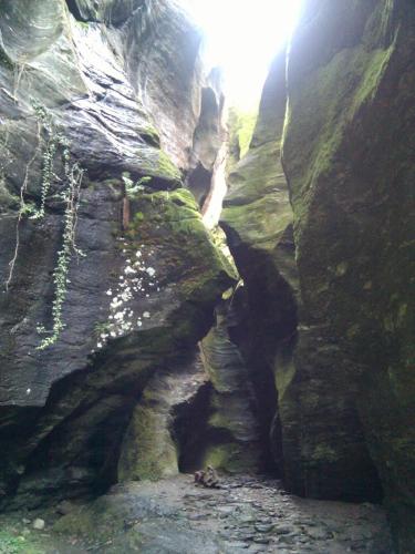 a large rock formation with a waterfall in a canyon at Casa Fattorini in Baceno