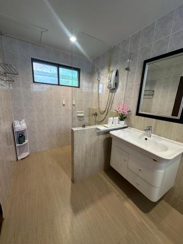 a bathroom with a sink and a shower and a mirror at Chaweng Bliss Bungalow in Chaweng