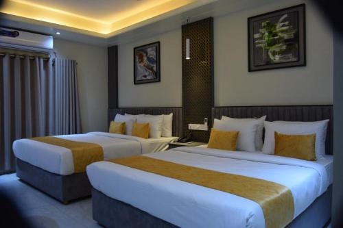 a hotel room with two beds in a room at The Swiss Hotel & Resort in Cox's Bazar