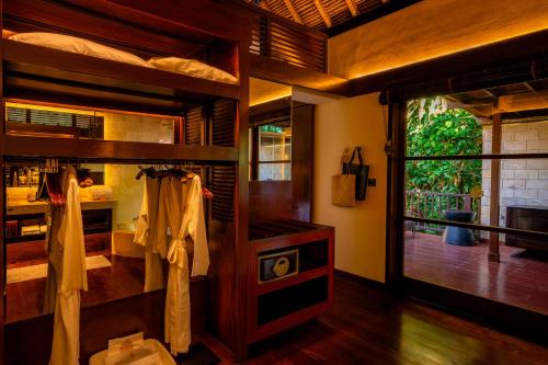a bedroom with bunk beds and a large window at Hanging Gardens of Bali in Payangan