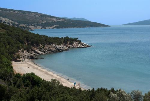 a view of a beach with people walking on it at Wavefront Serenity - Exotic & Dreamy Getaway in Marmarion
