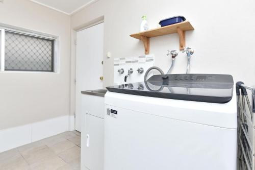 a kitchen with a sink on top of a refrigerator at Coal d' Vine VIEW - Cessnock NSW in Cessnock