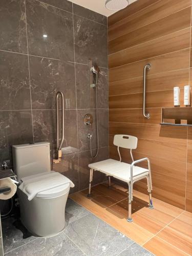 a bathroom with a toilet and a shower at The Pearl Kuala Lumpur in Kuala Lumpur
