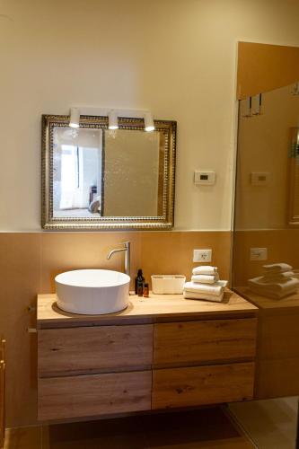 a bathroom with a sink and a mirror at SAGGEZZA Villa di GARGNANO in Gargnano