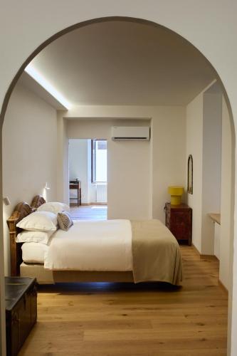 a bedroom with a large bed in an archway at SAGGEZZA Villa di GARGNANO in Gargnano