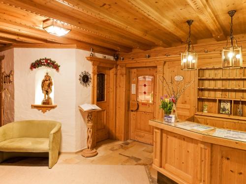 a large room with a bar in a wooden building at Pension Walkerbach in Lech am Arlberg