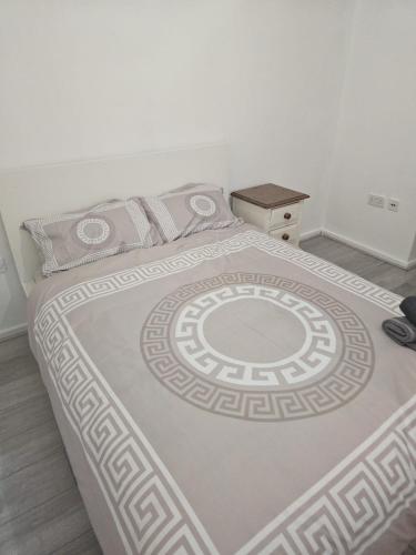 a bedroom with a large white bed with a table at 2bdr Ground Floor Flat in Edmonton free Parking and WiFi in Ponders End