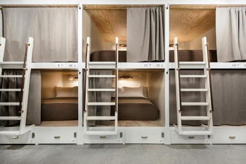 a group of bunk beds in a room at Cache House in Jackson
