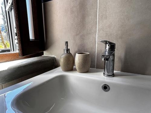 a white sink with two bottles on top of it at Ara Solis in Arola