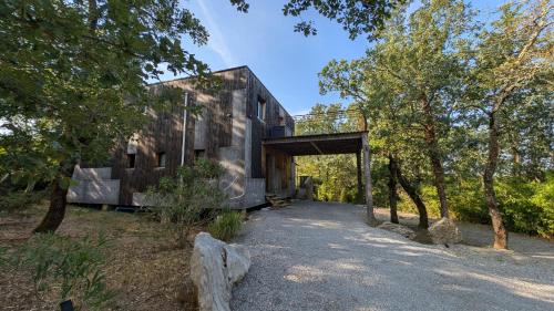 a building with a bridge over a road at Villa Mammouth in Saint Alban Auriolles