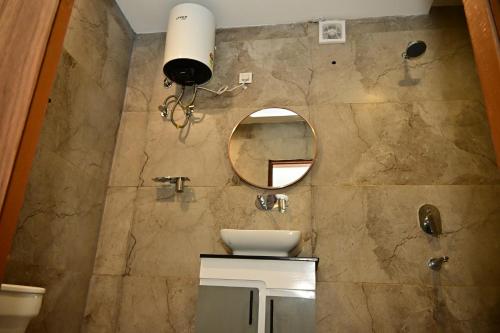 a bathroom with a sink and a mirror at Hotel Jiio in Kurukshetra