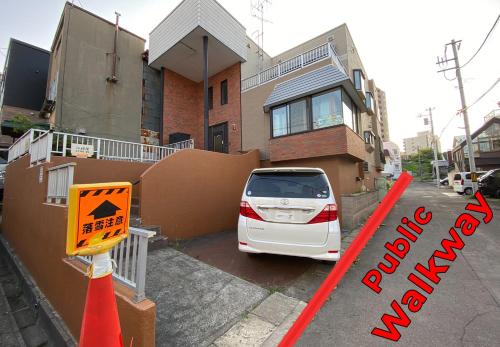 a white car parked in front of a house at Otaruya, Kitchen, Living Room, 2 Rooms, Max 7PP, Free Parking in Otaru