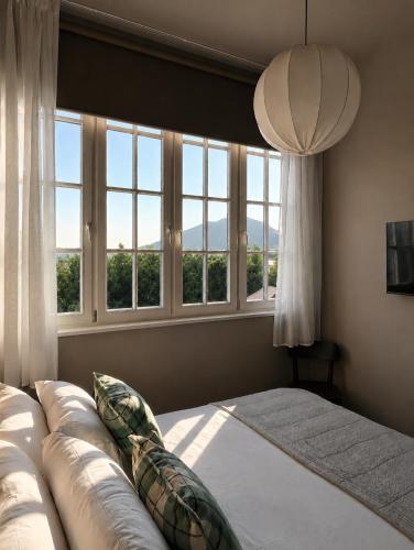 a bedroom with a large bed and windows at The Brewhouse Hotel in Edinburgh