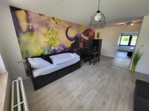 a bedroom with a bed and a desk in a room at Ferienwohnung Büffel in Niedenstein