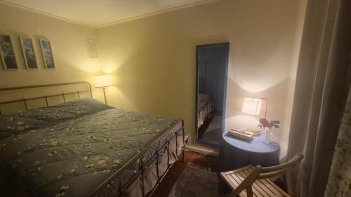 a bedroom with a bed and a table with a lamp at Anissa Shasta Hostel in Weed
