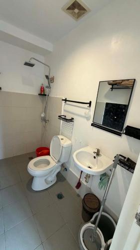 a bathroom with a toilet and a sink at Modena Town Square Minglanilla in Minglanilla