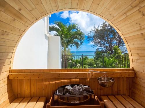 an outdoor sauna with an open window with a view of the ocean at -Villa Rikyu- 離宮 in Miyako-jima